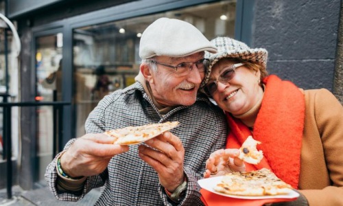 a couple eating pizza