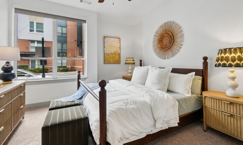 a bedroom with a bed and a window